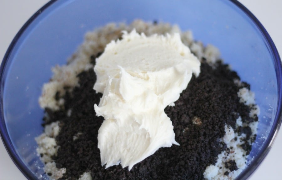 Adding cookie crumbs and buttercream to cake pop mixture