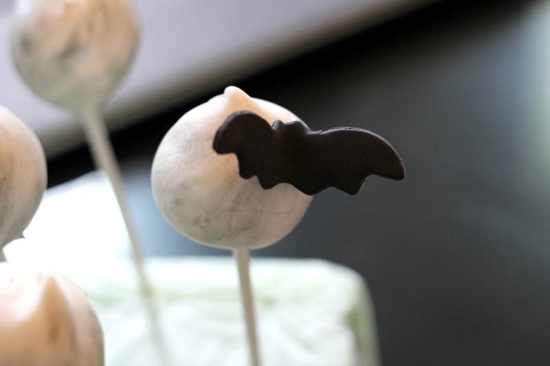 Attaching the fondant bats to the cake pops