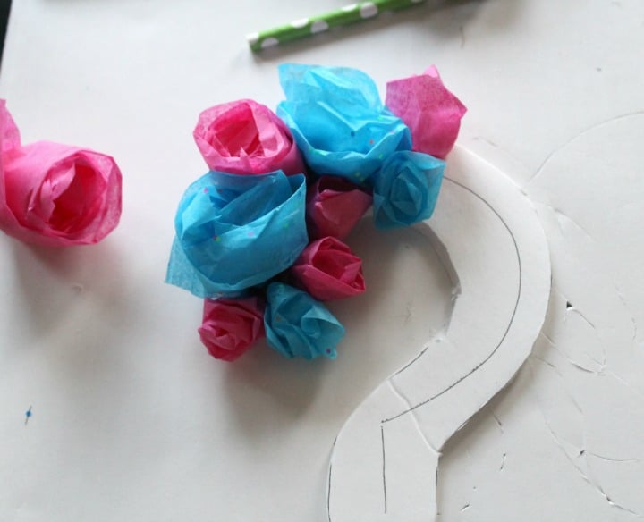 Adding the roses to the question mark cake topper