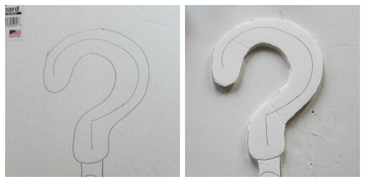 Cutting out the question mark cake topper