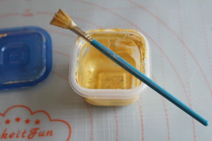 mixing the gold luster dust for the fondant leaves