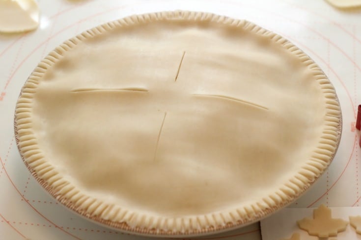 Adding the top crust to the apple pie