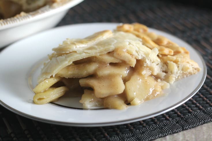 Close up view of apple pie on a white plate