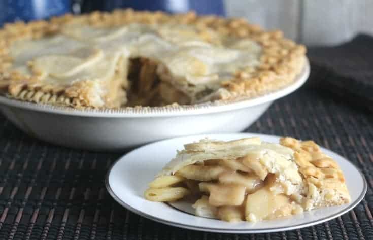 Slice of apple pie on a white plate