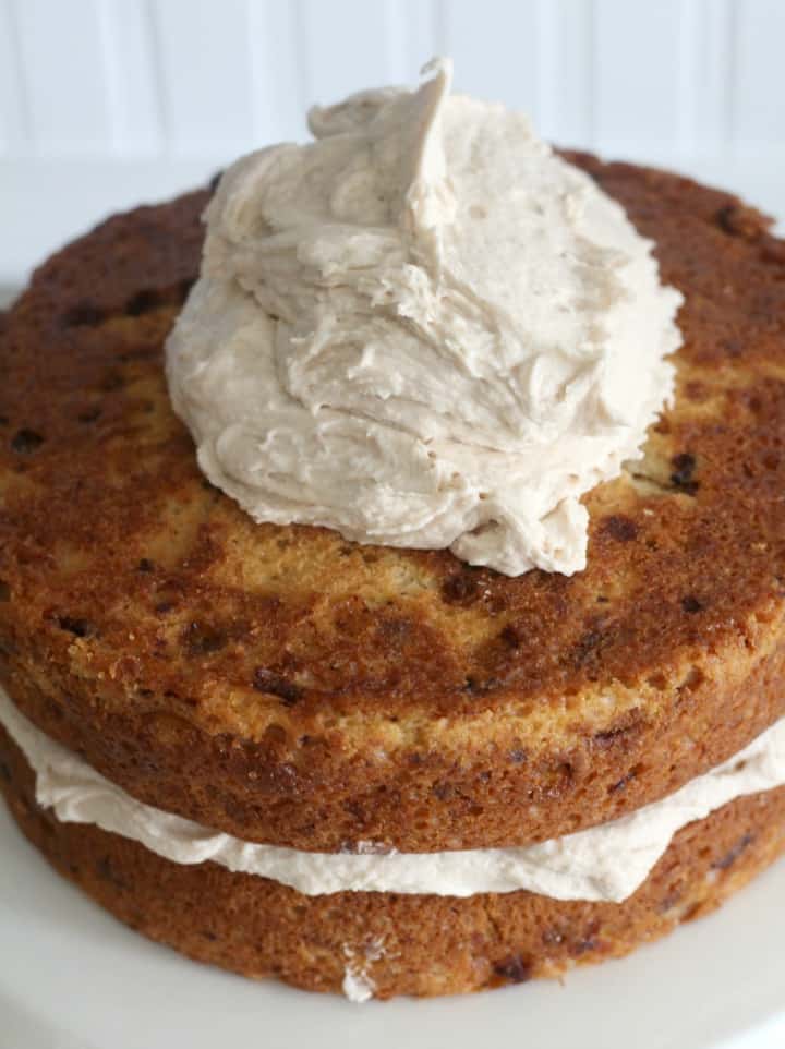 Adding buttercream to banana cake