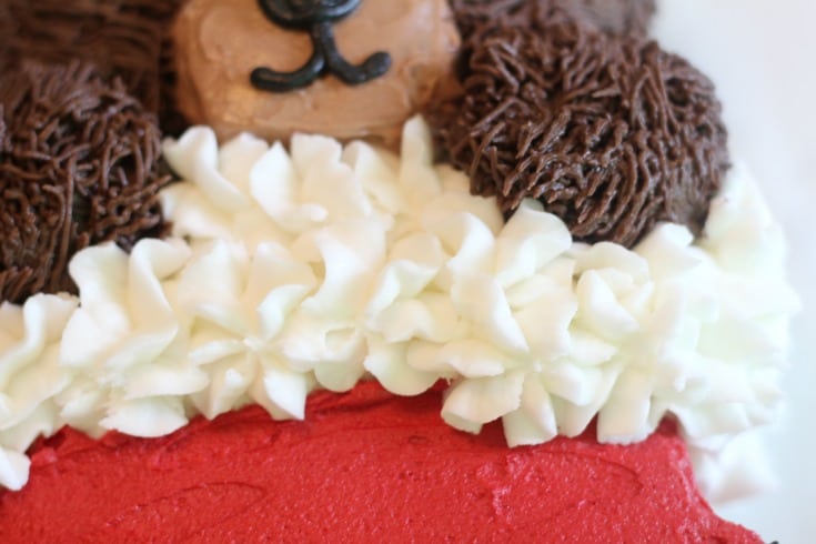 Piping ruffles on the stocking part of the christmas cake