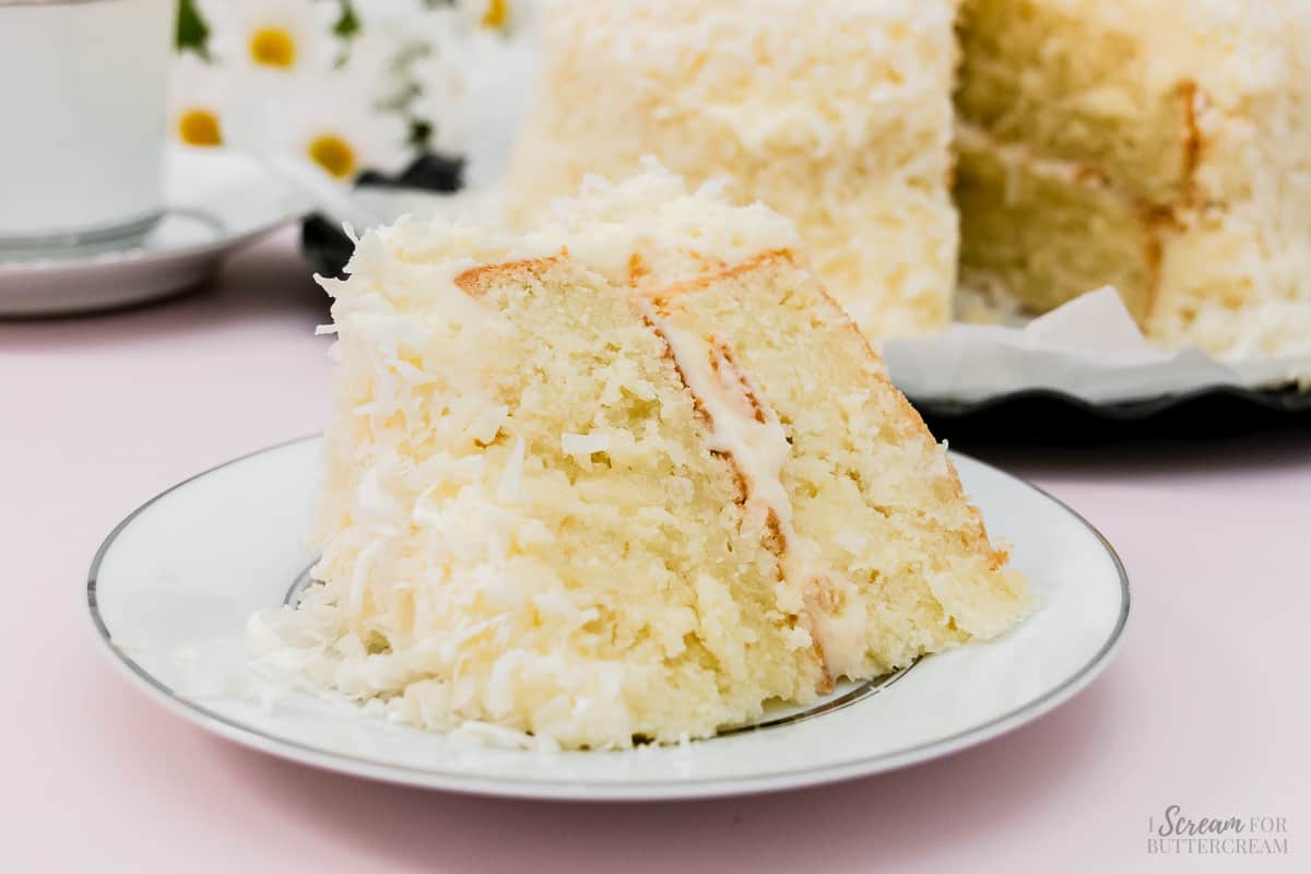 Large slice of southern coconut cake on a plate.