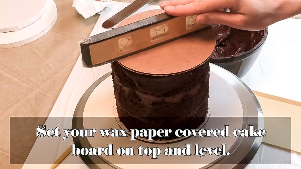 Cake with board and level on top.