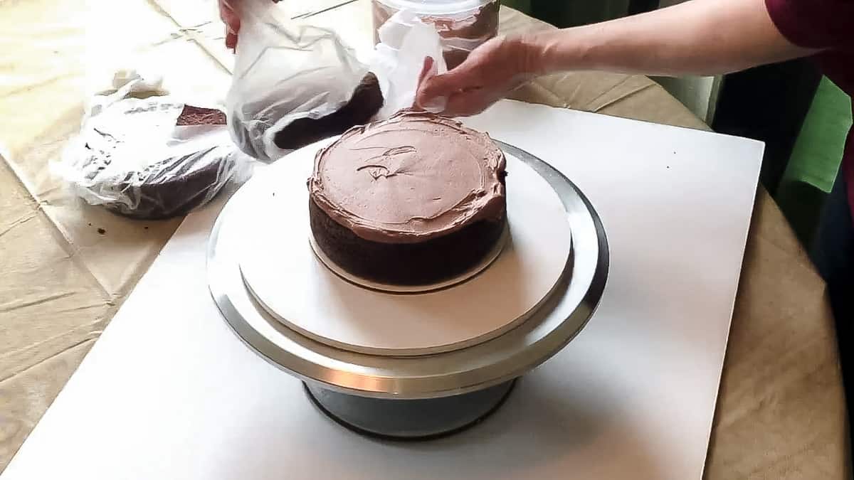 Stacking and filling ganache cake.