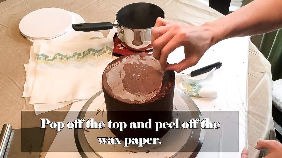 Peeling the top wax paper off cake.