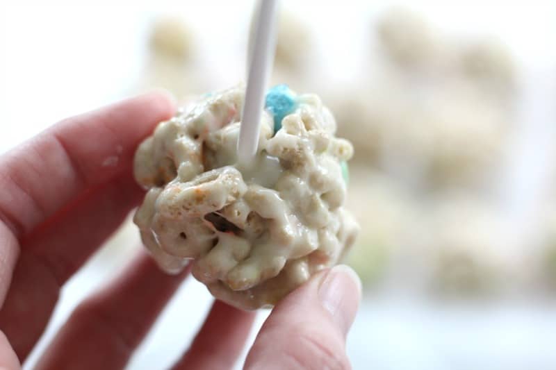 attaching popsicle stick to cereal pops