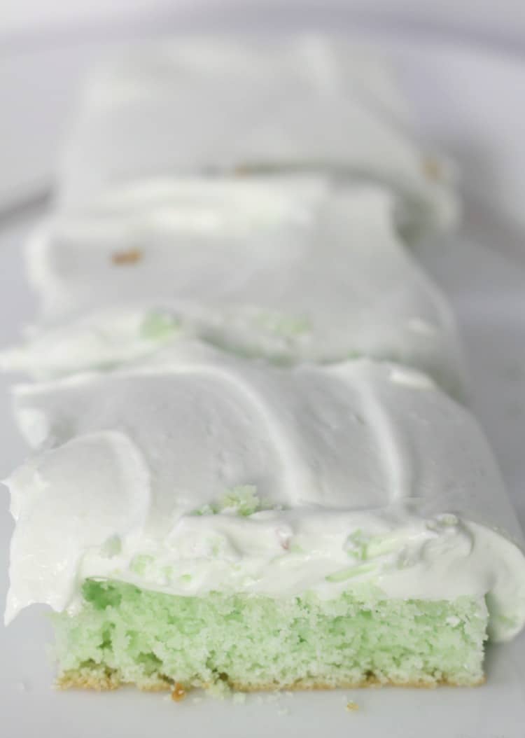 Key Lime Pie Cake Bars lined up on a white plate
