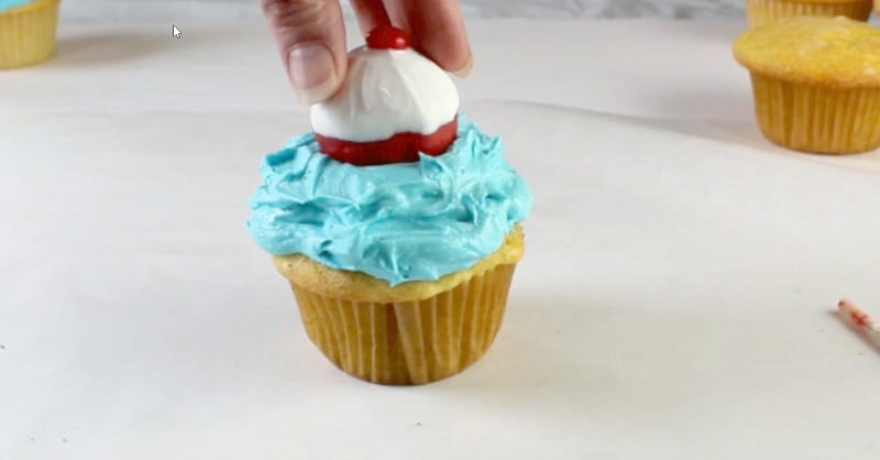 adding cake pop onto cupcake