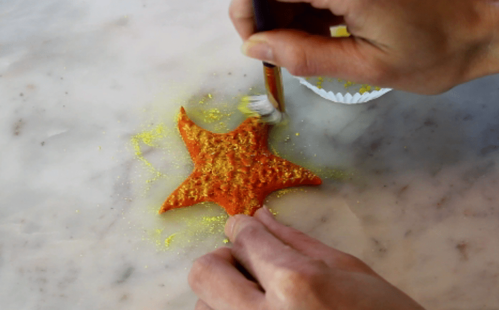 dusting red fondant starfish with yellow dust
