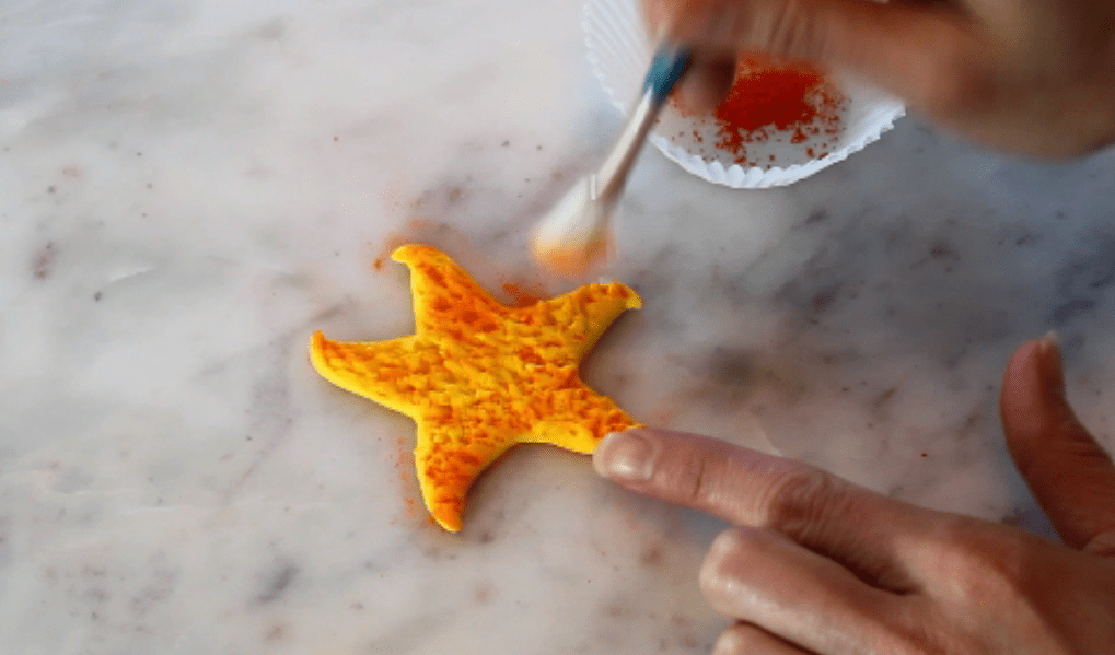 dusting yellow fondant starfish with orange dust