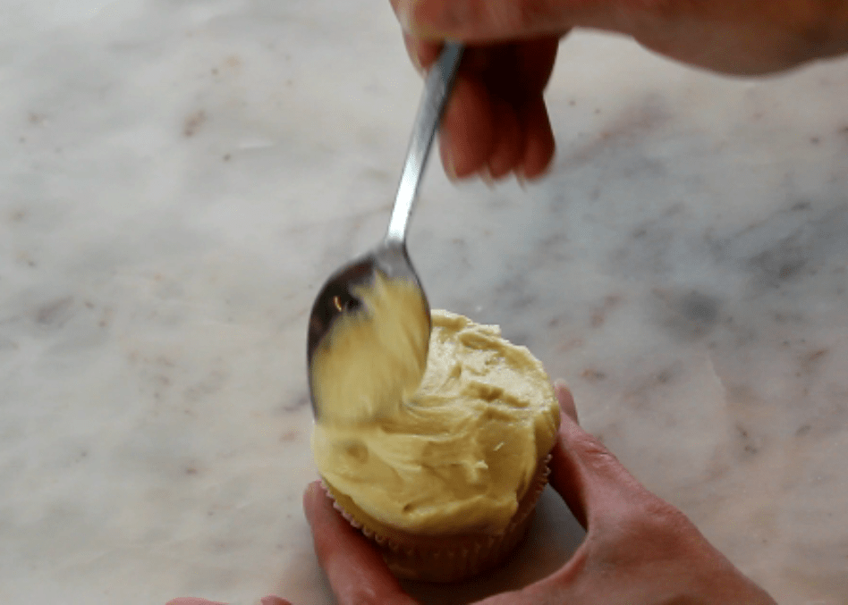 spread buttercream onto cupcakes