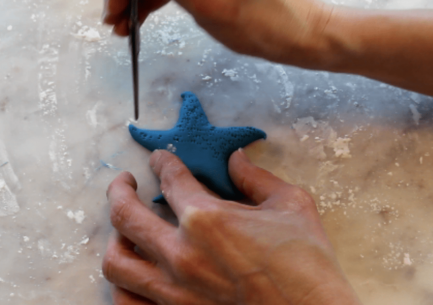 texturing the fondant star fish with scissors