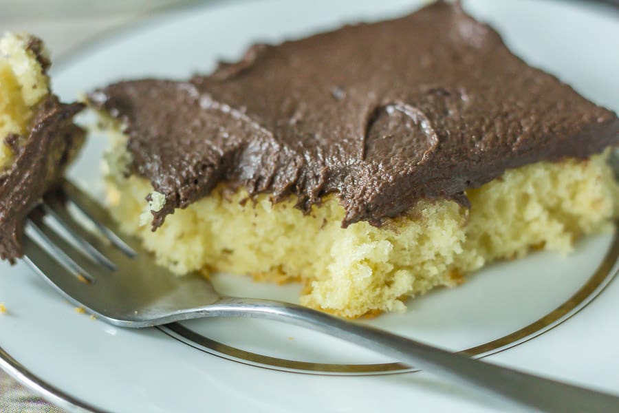 Yellow Buttermilk Sheet Cake on a plate with a fork