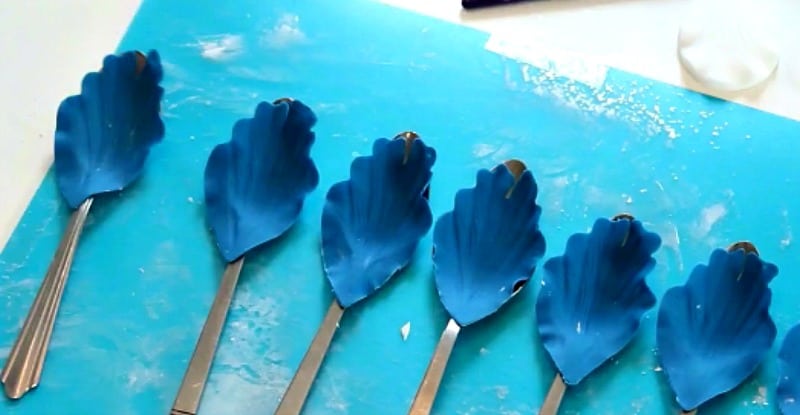 Drying blue gumpaste peony petals on spoons