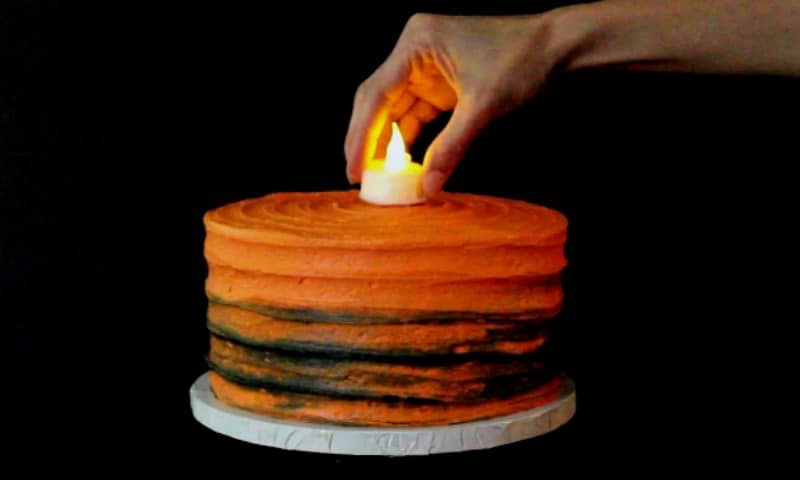 Adding tealight to cake