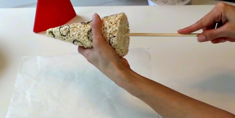 Inserting dowel into rice krispie party hat