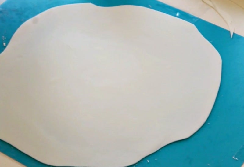 Rolling out white fondant for ghost cake topper