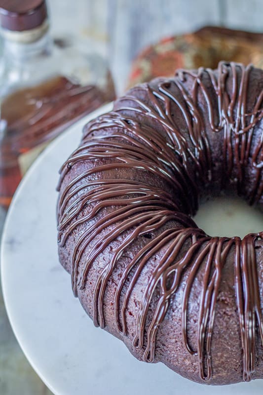 Side view of Chocolate Rum Cake on a marble cake stand