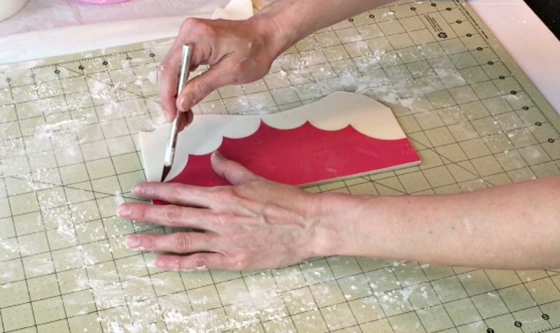 cutting fondant crown out around template