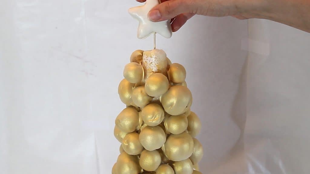 Attaching the Star Cake Pop to the top of the Cake Pop Christmas Tree
