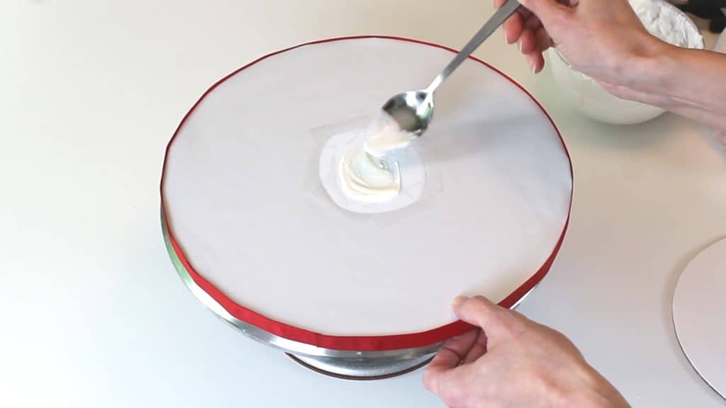 Adding melted candy melts to cake board