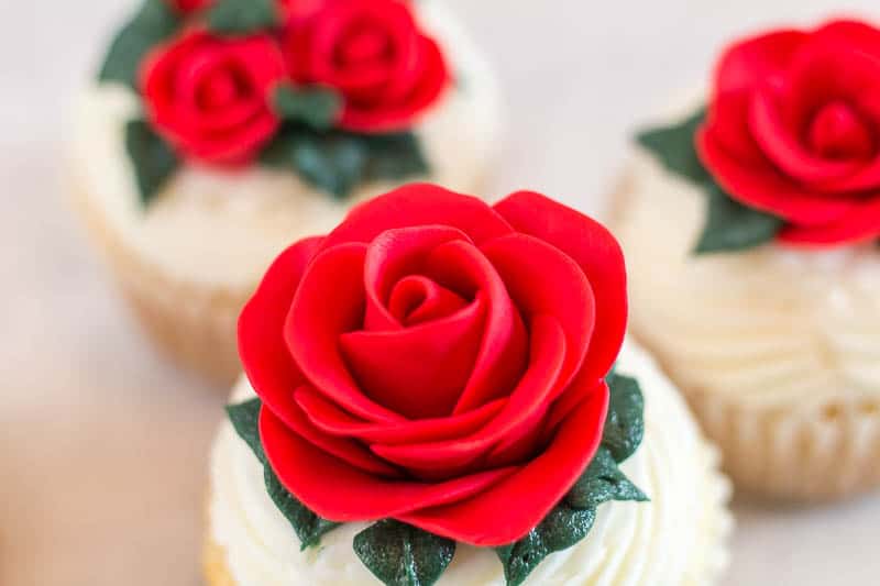 close up of large easy fondant rose on cupcake