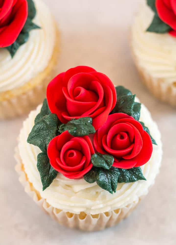 top view of three fondant roses on cupcake