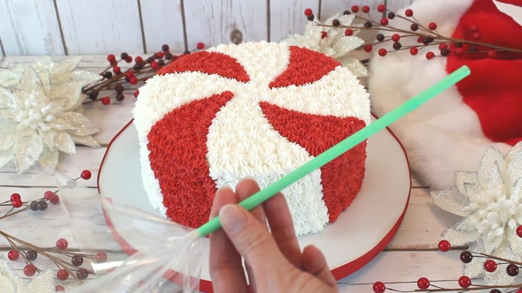 Inserting cellophane into straw for the peppermint candy cake