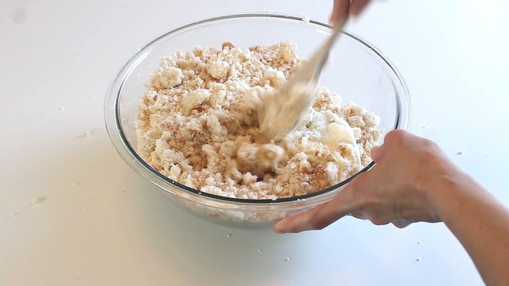 Mixing buttercream into cake crumbles to make cake balls