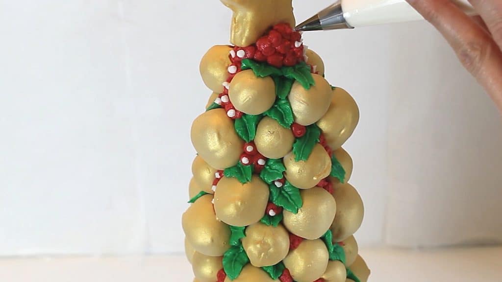 Piping berries onto the Cake Pop Christmas Tree