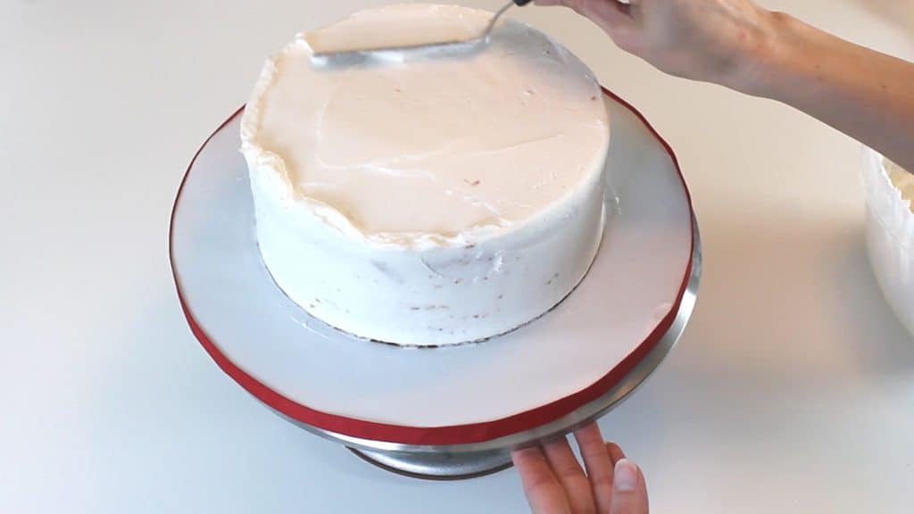 smoothing top of buttercream cake