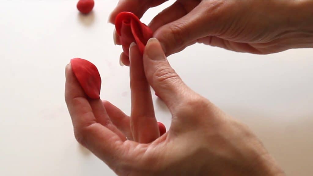 attaching fondant petals to rose bud