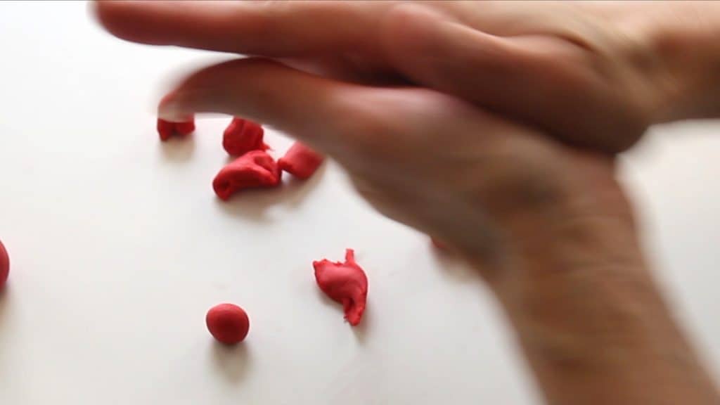 rolling fondant into balls to make rose petals