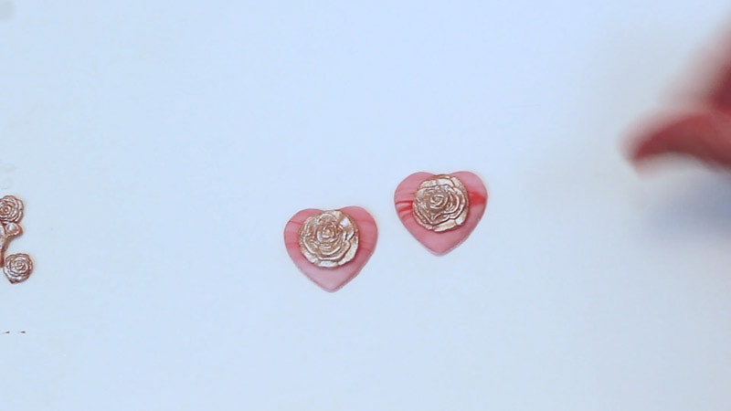 adding fondant embellishments to fondant hearts