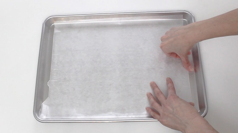 taping wax paper onto cookie sheet