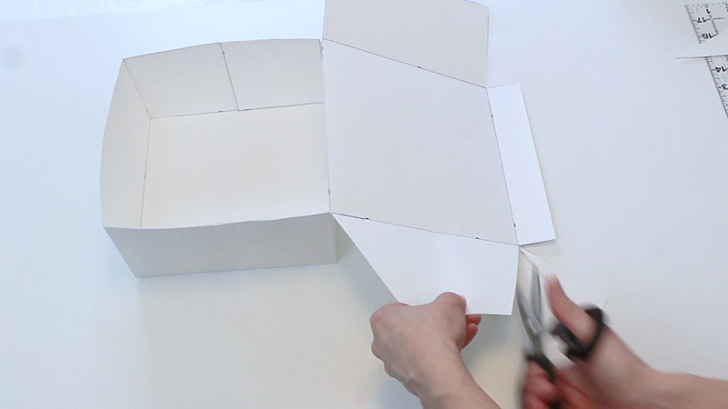 cutting the cardboard lid flaps at an angle