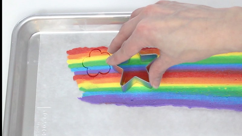 cutting out rainbow buttercream shapes