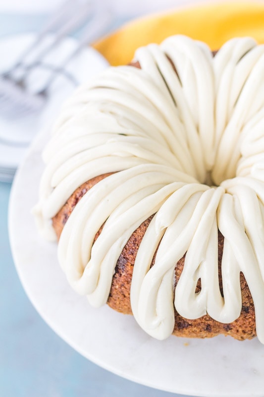 caramel carrot cake with glaze top view on a white cake pedestal 