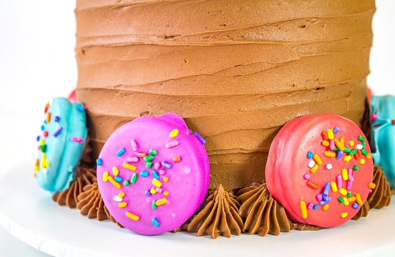 oreos dipped in candy melts attached to oreo insanity cake