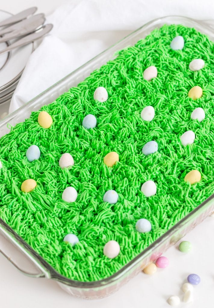 Easter bars with green buttercream that looks like grass with candy eggs on top