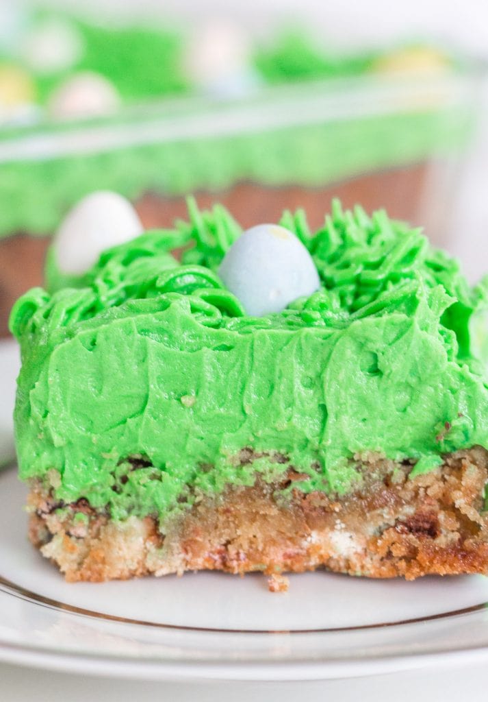 close up view of easter blondie bar with green buttercream icing on top