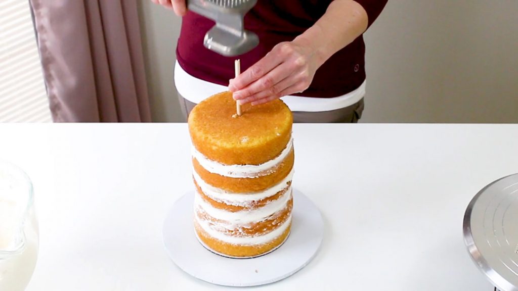 Hammer in center dowel into cake