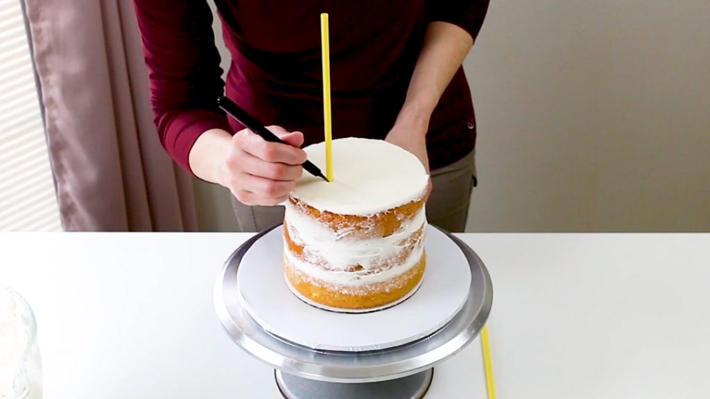 Mark the dowel at the top of the cake tier