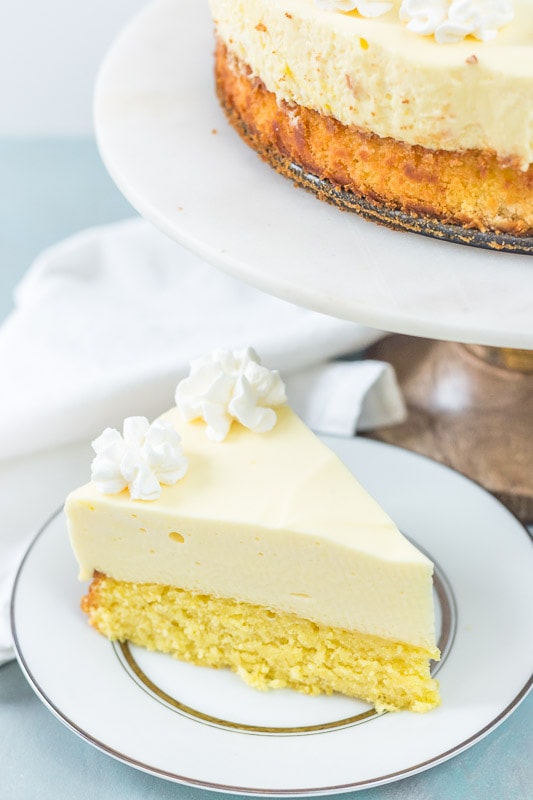 Slice of cake bottom lemon cheesecake on a white plate