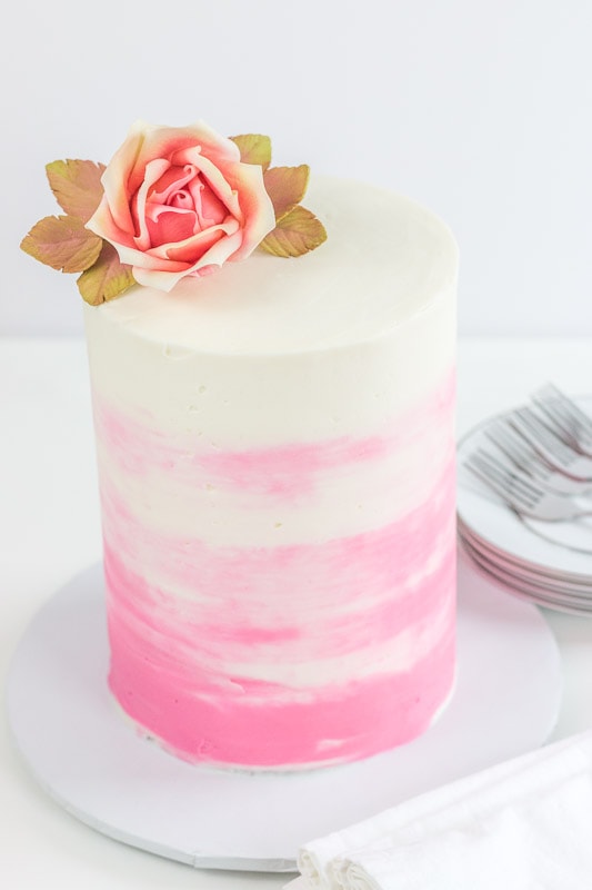 tall cake with rose on top